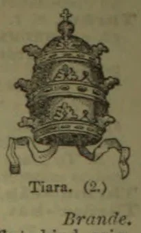 An ornate papal tiara with a cross at the top and ribbons hanging from either side.