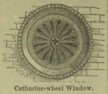 An engraved circular Catharine-wheel window with radiating stone tracery, shown set into a masonry wall.