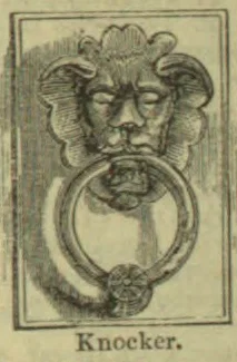 An ornate door knocker with a sculpted face and a circular ring hanging from its mouth.