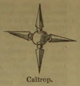 A four-pointed metal caltrop with a central body and spikes extending in four directions.