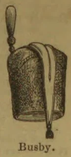 A tall fur military hat with a long hanging plume or cord and a tassel.