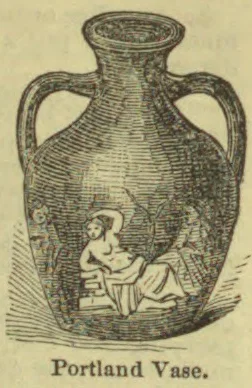 An ornate two-handled vase with a classical scene depicting figures near its base.