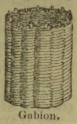A cylindrical woven basket-like gabion filled with stones.