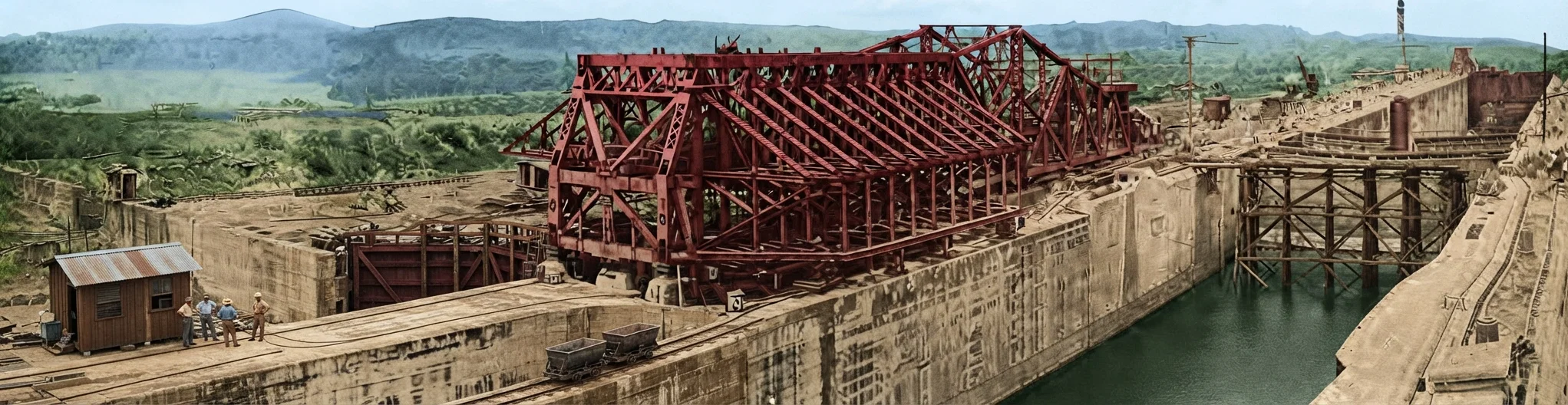 A PANORAMIC VIEW OF GATUN LOCKS, LOOKING DOWN TOWARD THE ATLANTIC OCEAN, AND The emergency dams shown at the right and left of the lock chambers may be swung across the channel, and the series of gates lowered, the