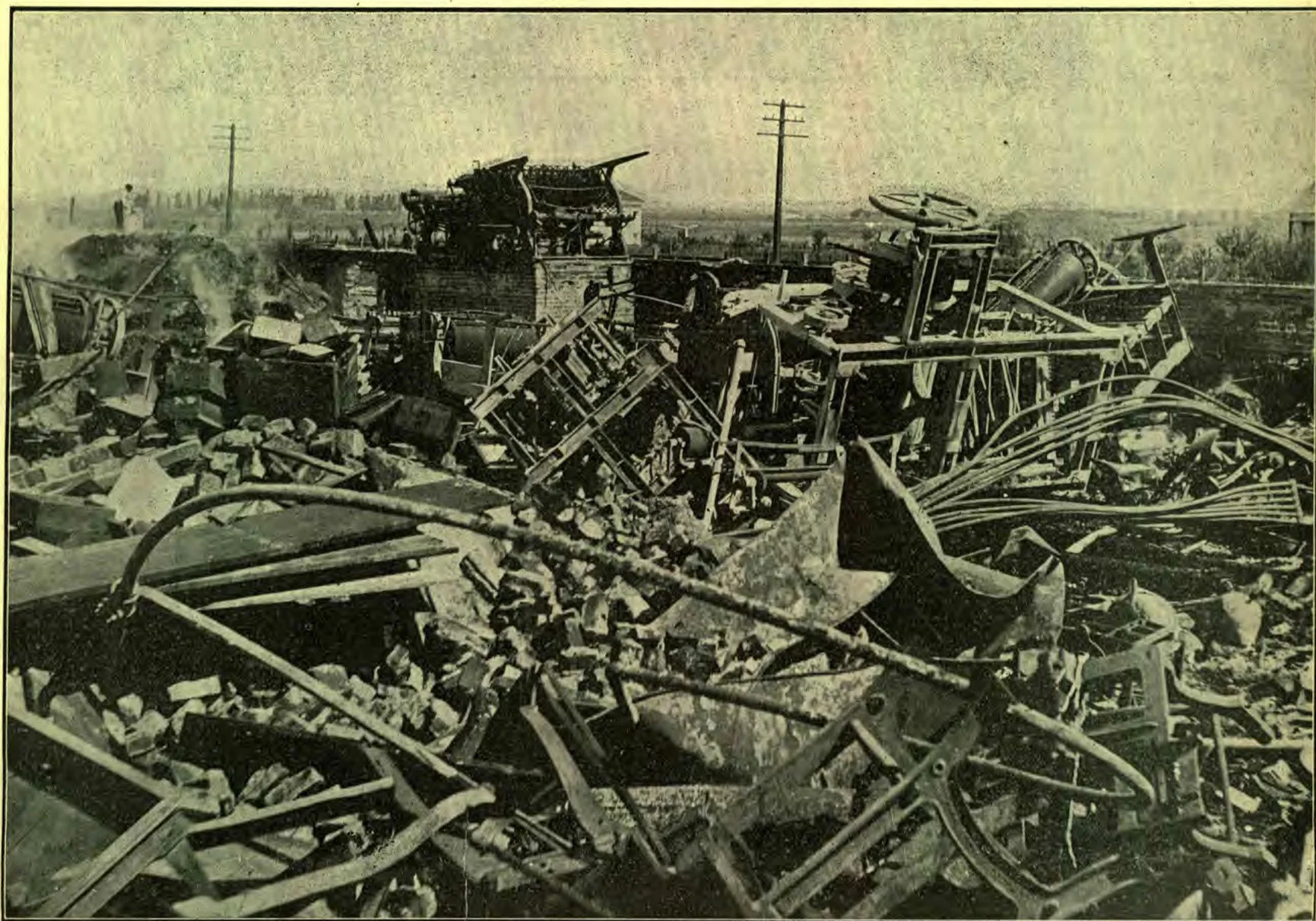 The ruins of some of the magnificent printing machines which have helped to herald the truth to the world. The press in the center background on the brick foundation is a Cottrell, which has run for twenty-five years, and was doing first-class work at the time of the fire. The large press at the right on its side is the SIGNS rotary press, installed in 1899. This issue is printed on a new Cottrell.