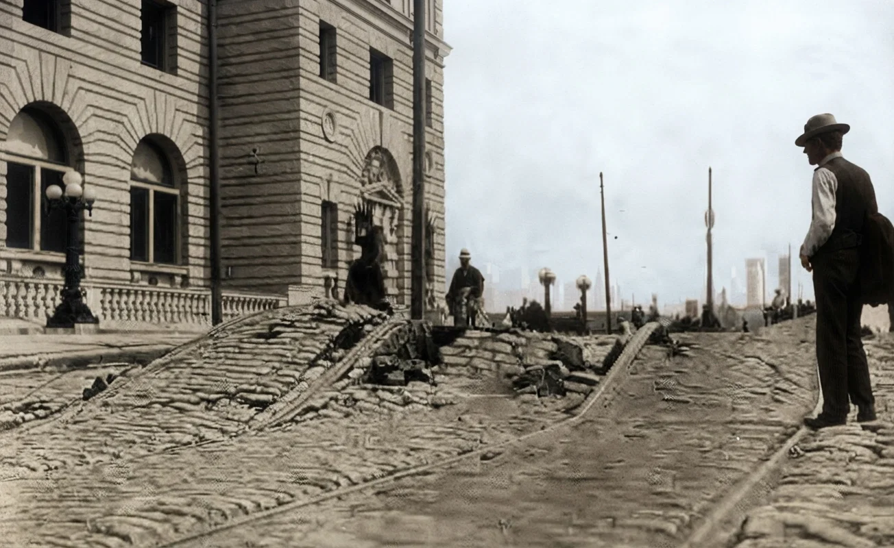 A view showing the power of the earthquake in front of the new Post Office Building, Seventh and Mission Streets. This street was previously level. The new Post Office Building was not greatly injured.