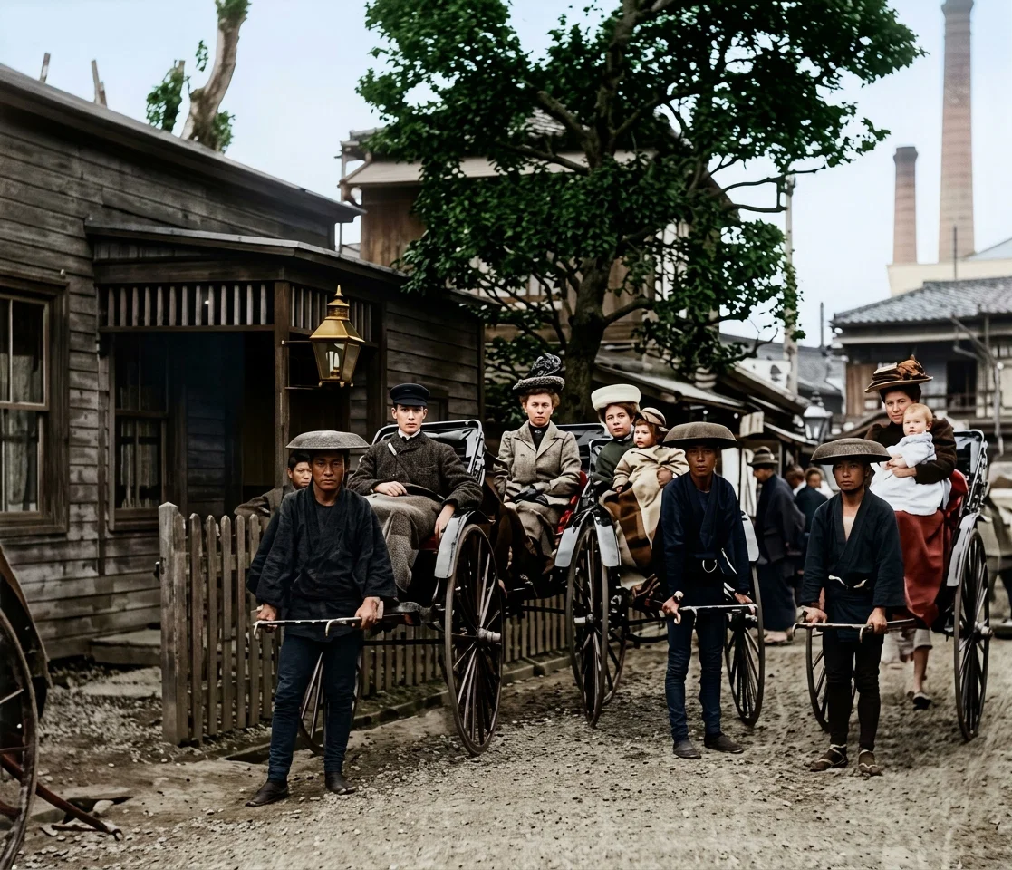 The picture of the 'rikisha men. Elder F. W. Field's house on the left. In the vehicles, naming from left, are Mr. Stafford, Mrs. Sparks, Mrs. Stafford and child, Mrs. Dr. Dunscomb and baby on the right. The picture was taken by Mr. Sparks, consequently he is not in the group.