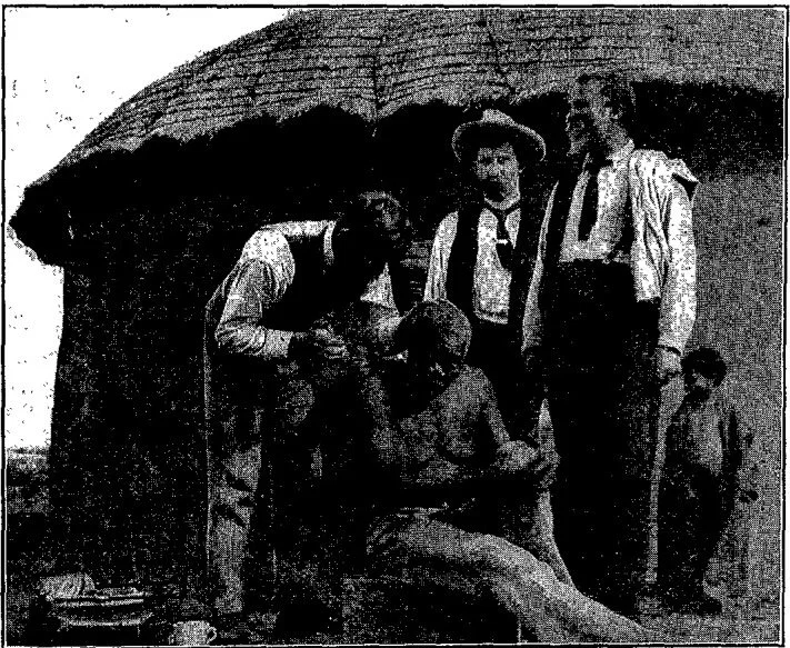 Photo by W. S. Hyatt
BROTHER BURTON TREATING A NATIVE OVER ONE HUNDRED YEARS OLD. ELDER ARMITAGE AND R. MOKO LOOKING ON