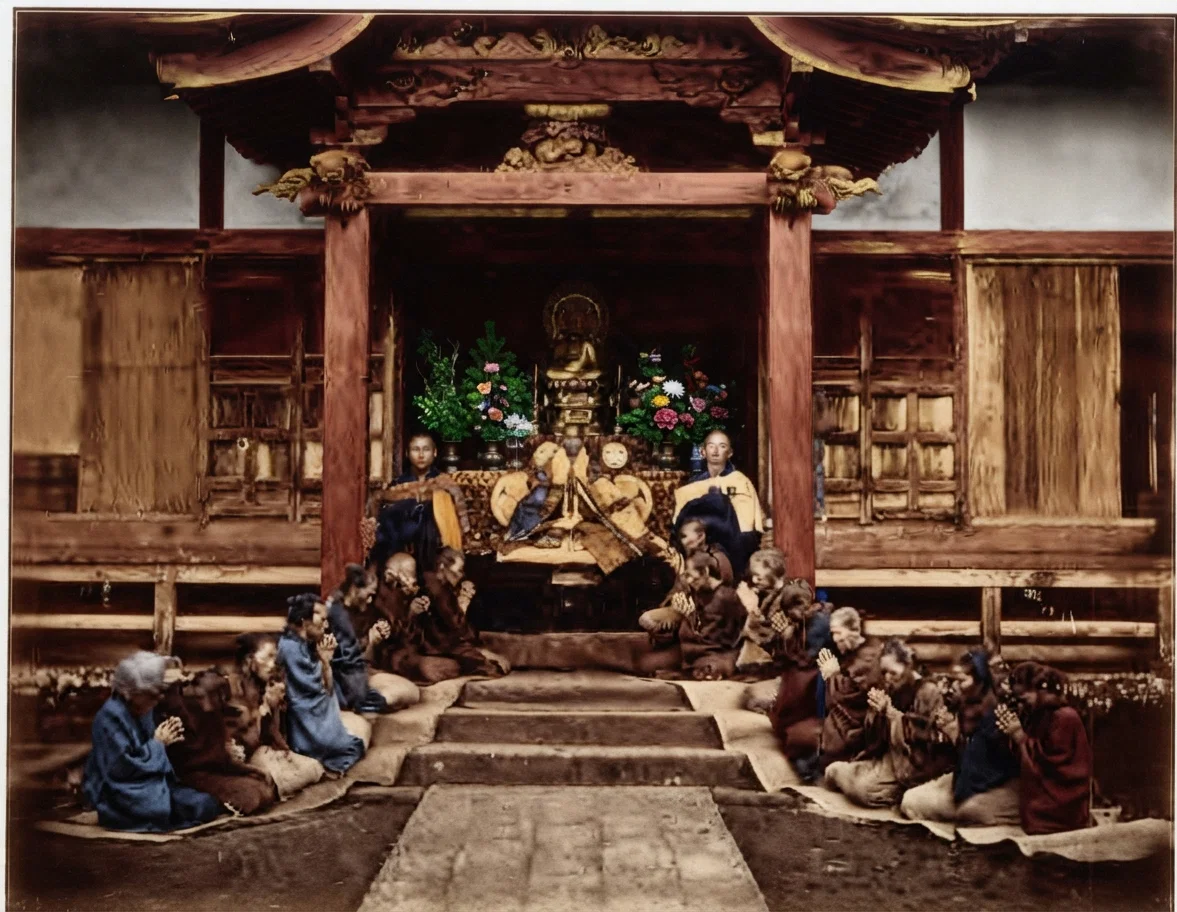 JAPANESE WOMEN WORSHIPING AT ENTRANCE TO A BUDDHIST TEMPLE.