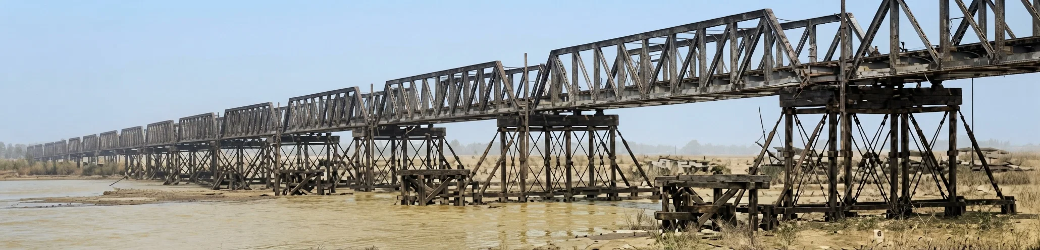 Railroad Bridge Spanning Yellow River, China. There are 103 piers, each span being about ninety feet, one hundred tons test.