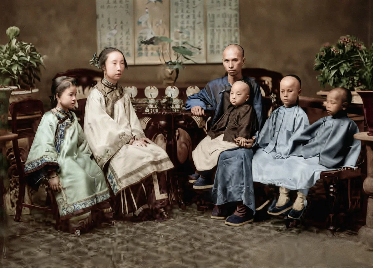 A mandarin with his family in their drawing-room. He is a state official, but his official dress has been laid aside.