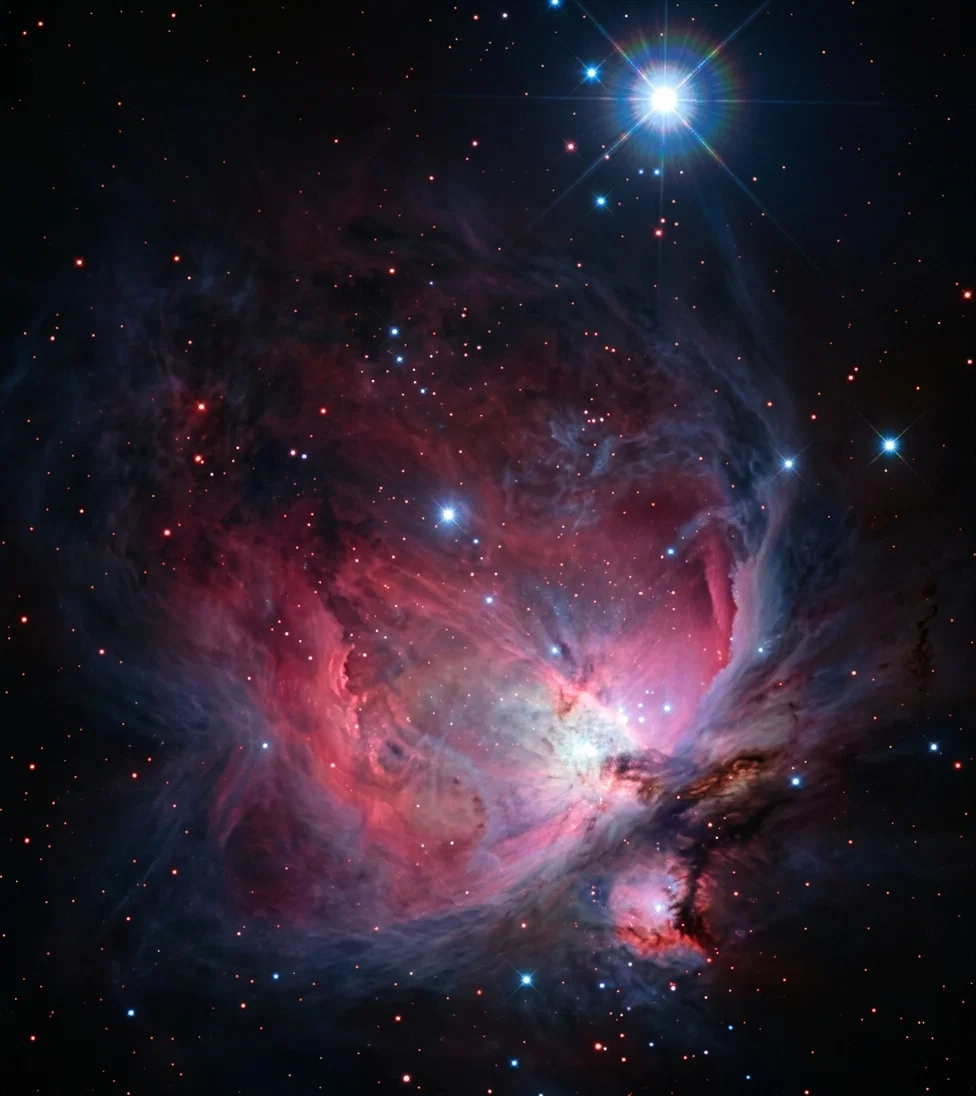 Photo from the Yerkes Observatory. The Nebula in Orion. This great opening shown as light in the photograph is many millions of miles across. Many of the stars that appear are larger than our own sun. It is one of the beautiful jewel caskets of the heavens.