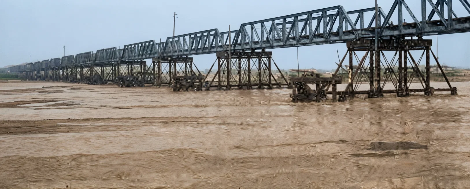 New R. R. Bridge, spanning Yellow River on the Hankow-Peking line. Length, 3,007 meters; number of piers, 103, each of 30 meters span. Built in two years by 17 Europeans. One hundred tons test.